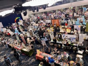Emily's photo shows a view of many exhibitor' tables taken from the balcony one floor above