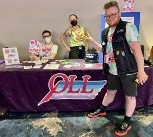 Emily's photo shows three representatives of QLL, one in front of the table and two behind